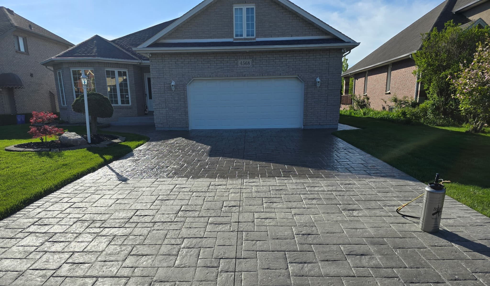 Stamped concrete driveway sealed with a rich wet look finish in Windsor Ontario by Preferred Coating Solutions